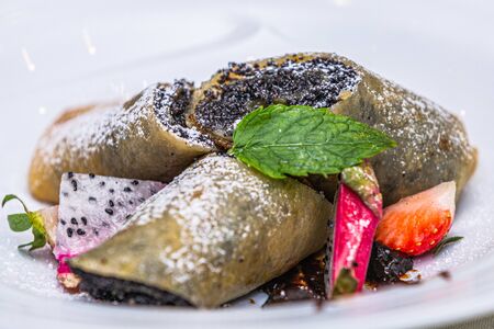 Delicious sweet pancakes with poppy seeds and fresh fruits. Closeupの写真素材