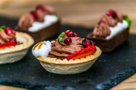 Sweet dessert Tartlets with different fresh fruit and delicious cream. Closeupの写真素材
