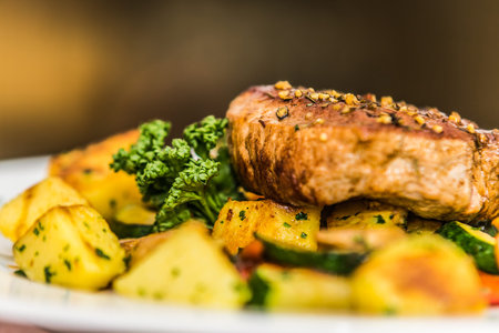 Juicy steak with potatoes and vegetables. The food in the restaurant. Food styling and restaurant meal serving.の写真素材