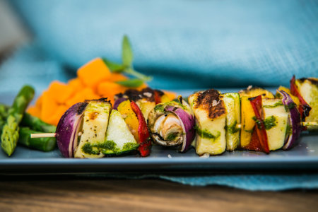 Grilled skewer with vegetables and mushrooms on plate with asparagus. The food in the restaurant. Food styling and restaurant meal serving.の写真素材