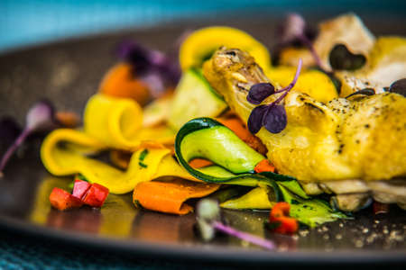 Chicken breast with slices of fresh vegetables. The food in the restaurant. Food styling and restaurant meal serving.の写真素材