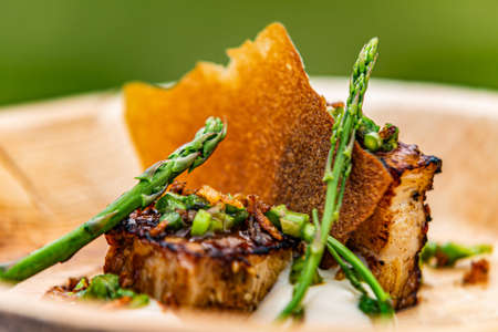 Roast lamb with chips and asparagus. Food styling for street food. Closeup.の写真素材