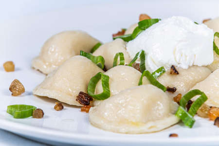 Potato dumplings with bacon and spring onions. The food in the restaurant. Food styling and restaurant meal serving.の写真素材