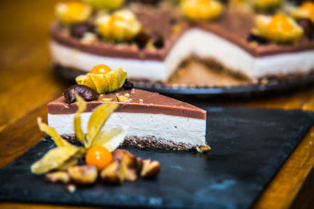 Light delicious yogurt cheesecake with physalis, nut and chestnuts  . Close upの写真素材