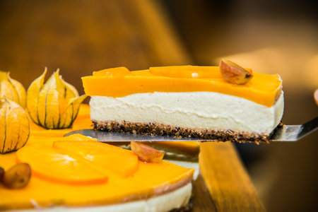 Light delicious yogurt cheesecake with physalis, orange and grapes . Close up