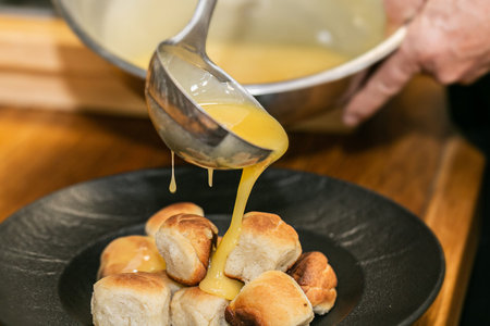 The chef is preparing homemade buns. Homemade delish dessert, vanilla sauce, fresh fruit. Close up