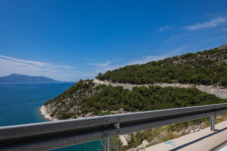 Croatia road. Croatia - Adriatic Highway (Jadranska Magistrala) road along the coast. Croatia. Beautiful nature and landscape. Coastal Road and Sea in Summerの写真素材