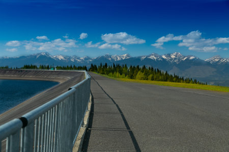 A view of the Cierny Vah hydroelectric power plant. High Tatras scenery. Monumental peaks over water level.の写真素材