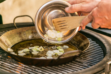 The chef prepares a traditional seafood paella on the grill.Traditional spanish dish. Fresh and Colorful Spanish Seafood Paella. Mediterranean cuisine and seafood dishes.の写真素材