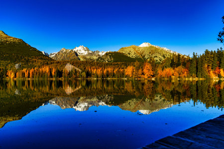 Wide landscape view of the snow-capped High Tatra mountain range in Slovakia. The peaks are...