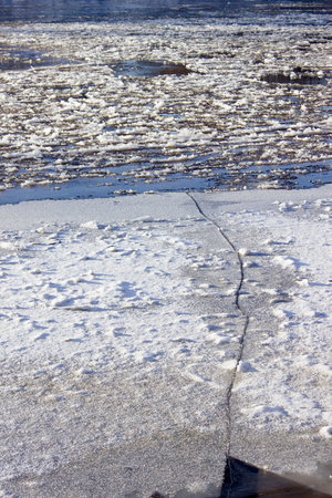 cracked ice on river in spring timeの写真素材