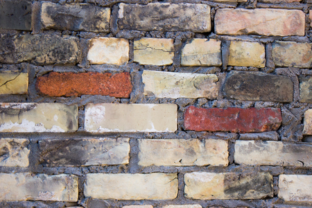 A red and grey old brick wall background.の写真素材