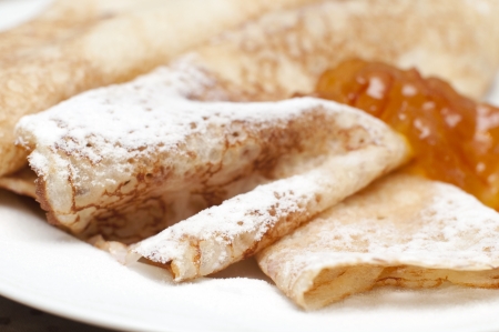 close up of crepes with powdered sugar and jamの写真素材