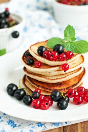 Close up of pancakes topped with fresh berries and mint, selective focusの写真素材