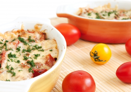 Close up of baked vegetables in ceramic dish isolated on whiteの写真素材
