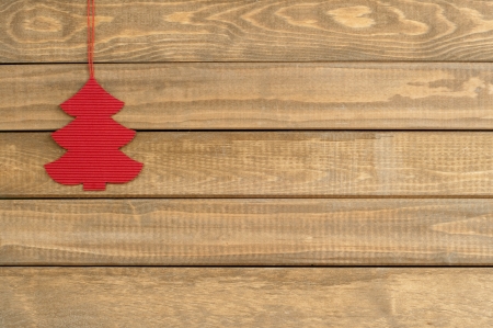 Christmas toy fir tree hanging over wooden background, horizontalの写真素材