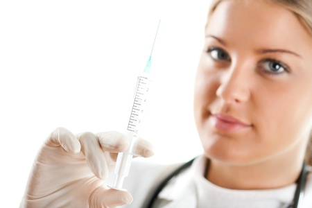 Female doctor holding a syringe in her handの写真素材