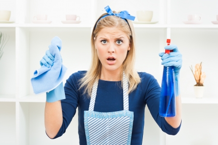 Young housewife is in panic because there is a lot to clean の写真素材