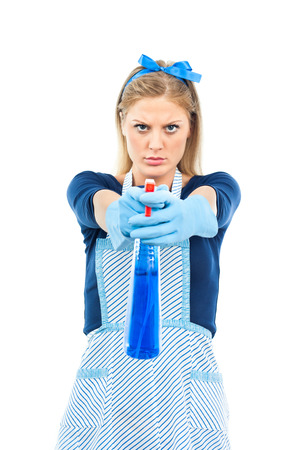 Beautiful housewife pointing cleaning spray bottle in camera の写真素材