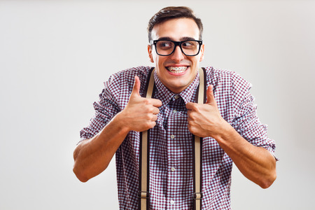 Happy nerdy man is showing thumbs up.の写真素材