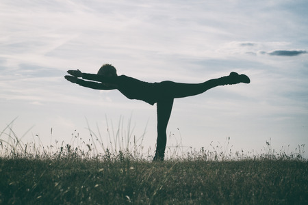Yoga-Virabhadrasana III /Warrior Pose III,intentionally toned imageの写真素材