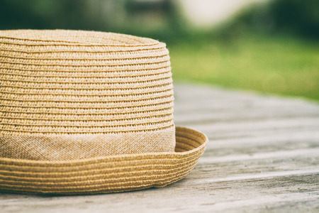 Photo of hat on wooden table,intentionally toned image.の写真素材