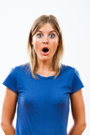 Young woman is very shocked because of something.の写真素材