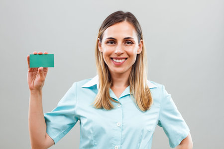 Portrait of beautiful showing business card.の写真素材