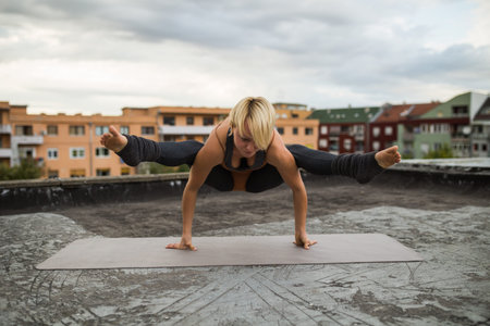 Beautiful woman practicing yoga on the roof.