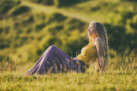 Beautiful woman enjoys spending time in the nature.Image is intentionally toned.の写真素材