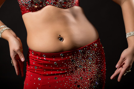 Image of belly dancer performing belly dance on black background.の写真素材