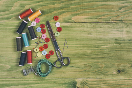 Sewing accessories on wooden table.Image is intentionally toned.