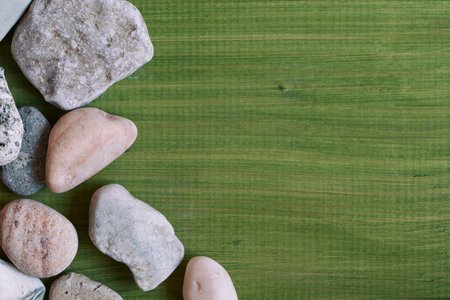 Image of sea stones on wooden table.Image is intentionally toned.の写真素材