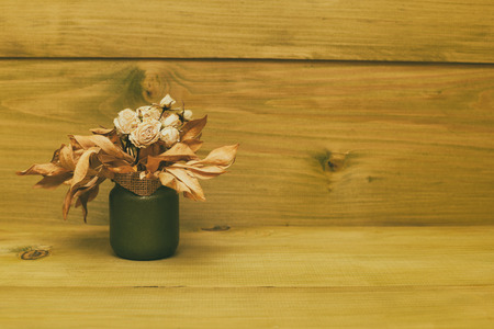 Vase with dried flowers on wooden table.Toned photo.の写真素材