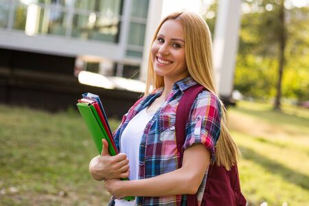 Portrait of beautiful female student standing outdoor.の写真素材
