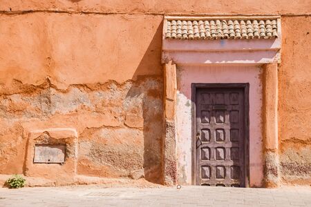 Image of wooden old door  and part of the house in Morocco.の写真素材