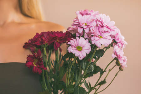 Woman holding beautiful bouquet of flowers.Focus on flowers.の写真素材
