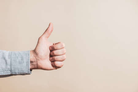 Close up image of male hand showing thumb up.の写真素材