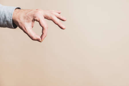 Close up image of male hand in picking gesture.の写真素材
