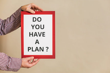 Image of man holding paper with text do you have a plan