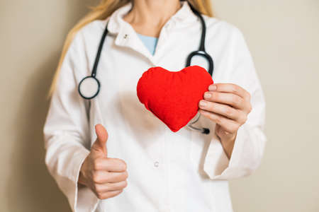 Image of  female doctor showing heart shape and thumb up.の写真素材