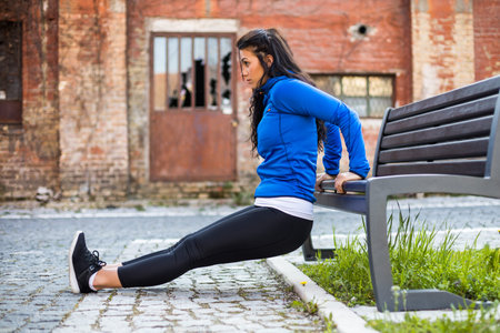 Beautiful woman enjoys exercising outdoor.