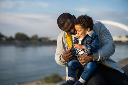 Happy father and his son enjoy spending time together outdoor.の写真素材