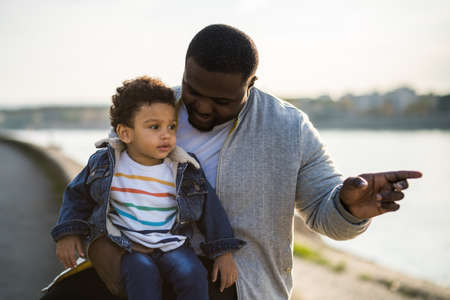Happy father and his son enjoy spending time together outdoor.の写真素材