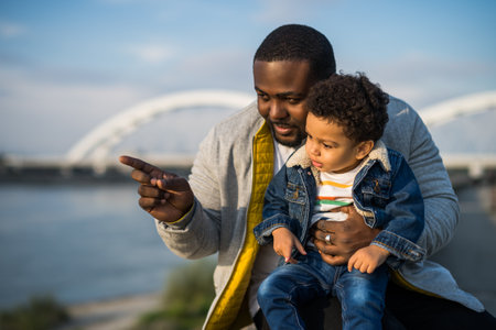 Happy father and his son enjoy spending time together outdoor.の写真素材