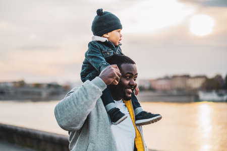 Happy father and his son enjoy spending time together outdoor.の写真素材