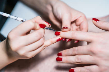 Close up image of manicure process ,manicurist painting fingernails. Focus on fingernail.の写真素材