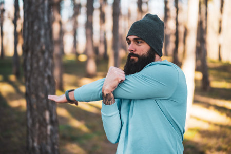 Man with beard enjoys exercising in nature.の写真素材