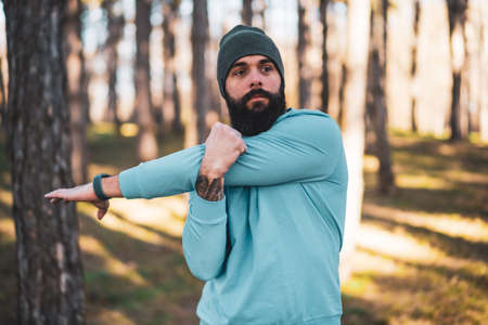 Man with beard enjoys exercising in nature.の写真素材