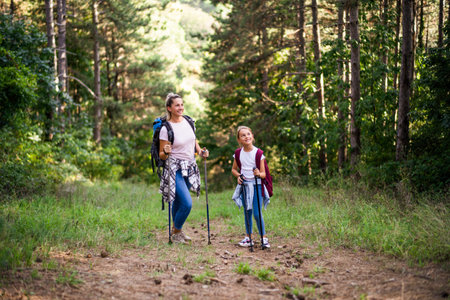 Mother and daughter enjoy hiking together.の写真素材